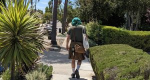 My husband walking away with teal green hair, wearing a utilikilt
