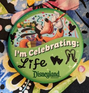 Disneyland pin that says "I'm celebrating Life"