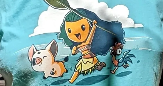 close up of Moana t-shirt where Moana, HeHe and the pig whose name I can't remember are joyfully running towards adventure