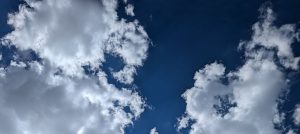 blue sky filled with white clouds limned with sunlight